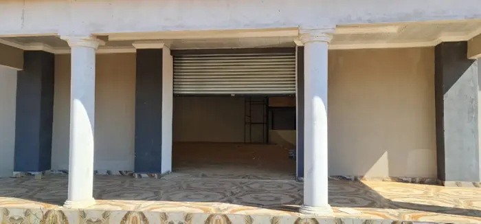 Shop roller shutter behind a colonnade