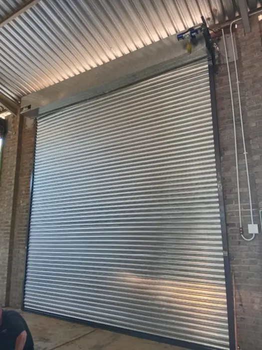 Galvanised roller shutter under a canopy