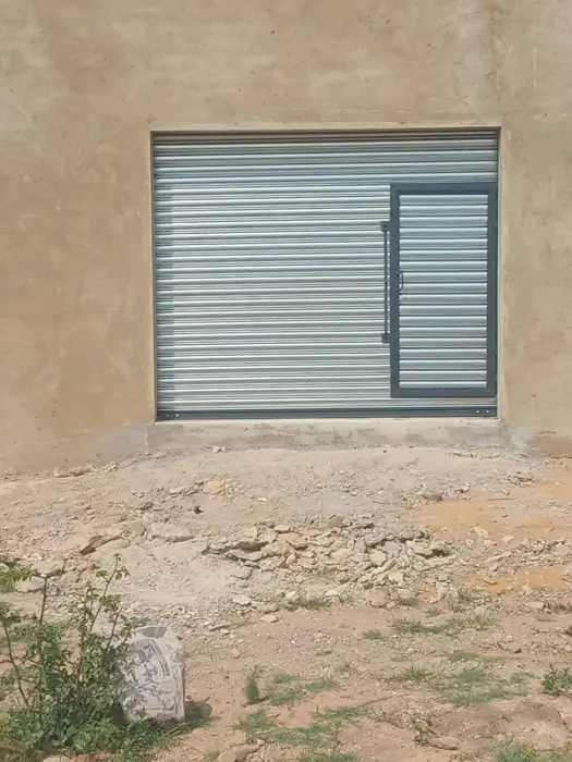 Roller door with pedestrian wicket door