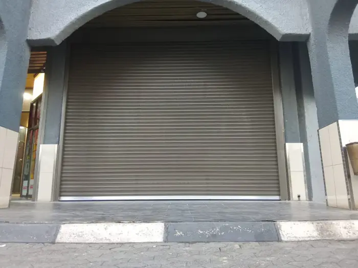 Shopfront roller shutter in an arched entrance